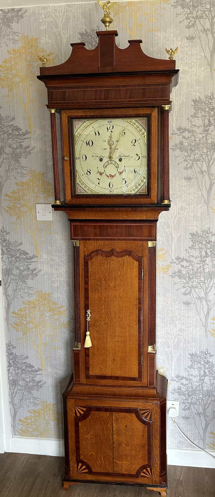 Grandfather Clock with Wooden Case Grandfather clock with a polished wooden case and classic clock face, showcasing traditional craftsm.